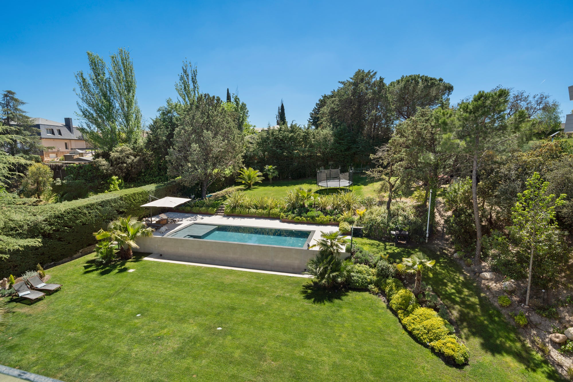 Aerial view of a villa and its gardens at golden hour