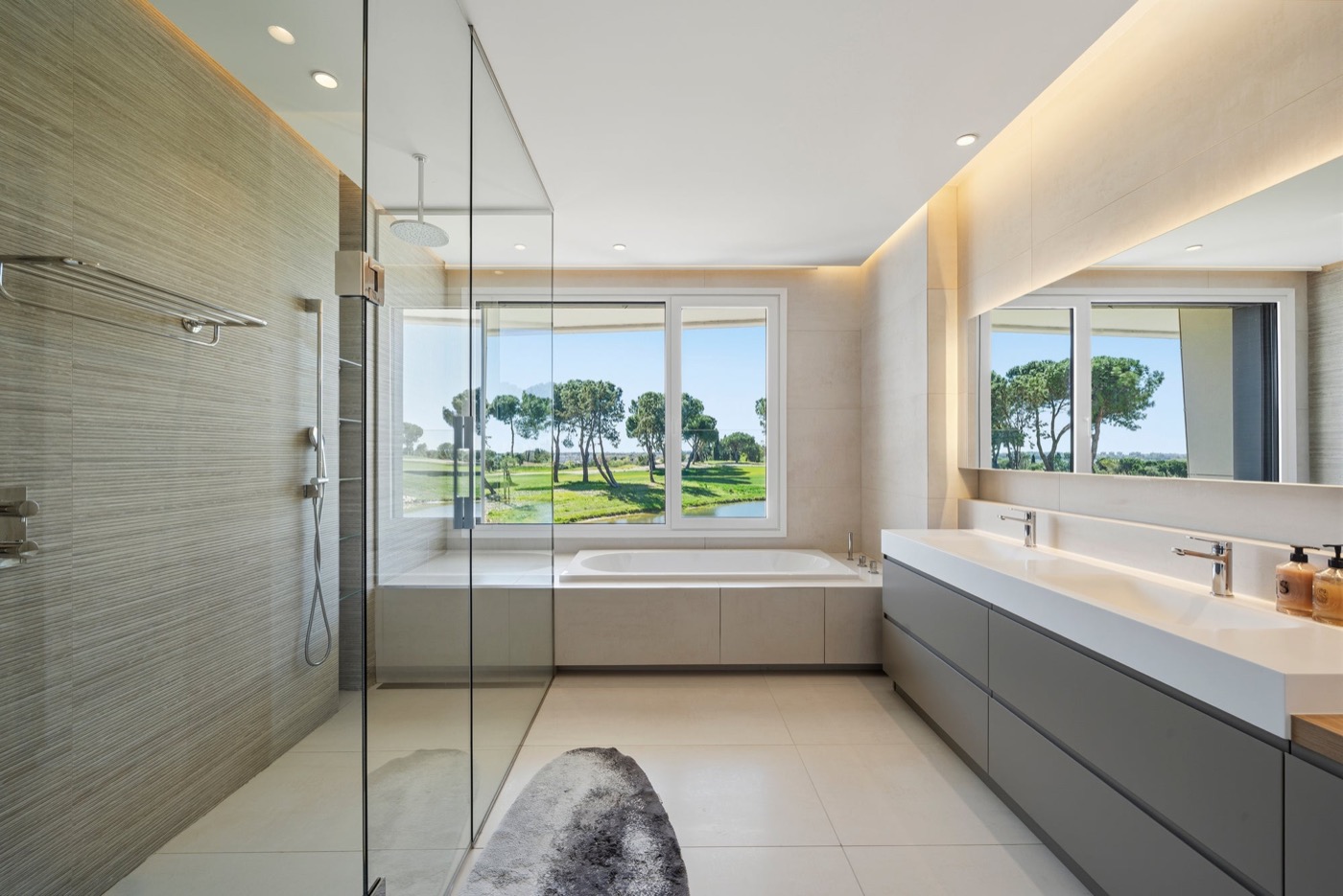 Bathroom with glass shower and golf course views