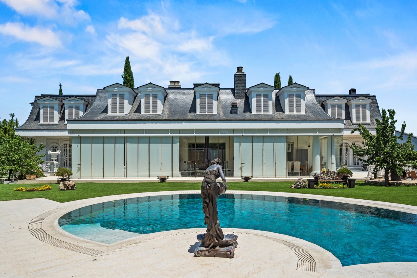 Classic estate with circular pool and bronze statue
