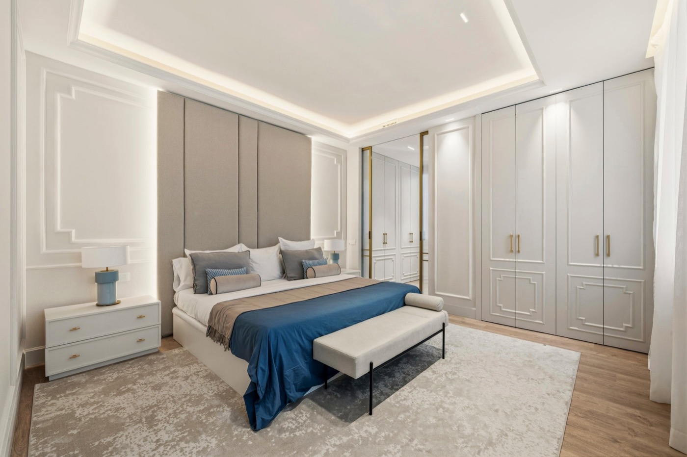 Master suite with sculpted headboard and cove lighting