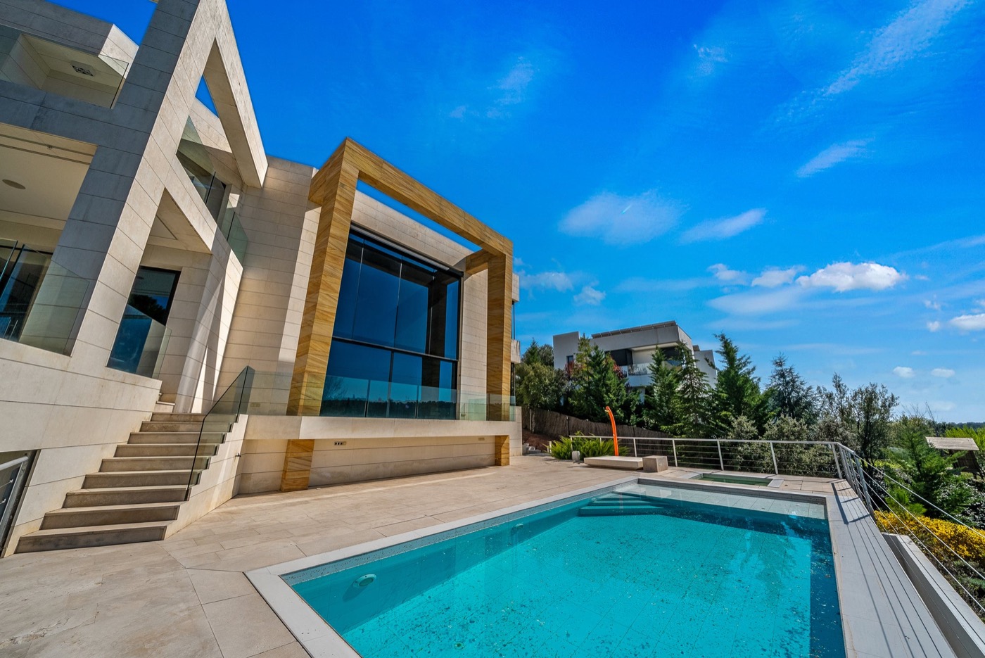 Sculptural stone and wood villa with pool